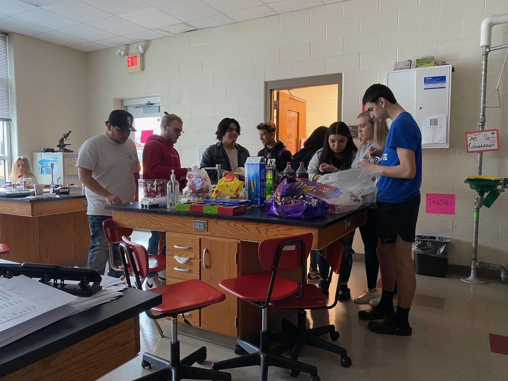 Students grabbing treats that were brought in from home. Students Pictured left to right: Edgar Meza-Huerta, Jordan Grant, Eddie Shook, Hector Feliciano Ortiz, Silvia Lopez, Addison Hollar, and Aaren Smith. 